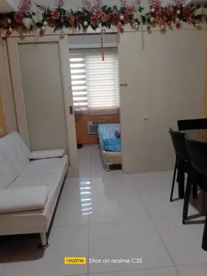 a living room with a couch and a table at Kaoru Properties in Manila