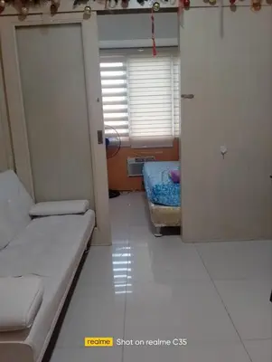 a room with a couch and a bed in it at Kaoru Properties in Manila