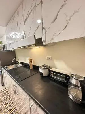 a kitchen with a counter top with a stove at Cg's Staycations in Manila