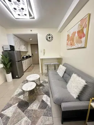 a living room with a couch and two tables at Cg's Staycations in Manila