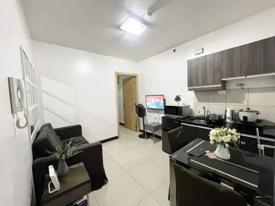 a room with a kitchen and a living room at Solemare parksuites with balcony tower C in Manila