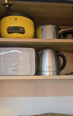 a shelf with pots and pans and a toaster at Hygge-ParkWest BGC near Grand Hyatt & Mitsukoshi in Manila