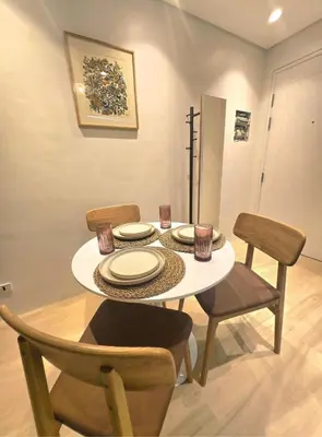 a dining room table and chairs with a white table and chairsktop at Hygge-ParkWest BGC near Grand Hyatt & Mitsukoshi in Manila