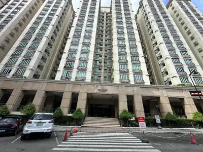 a large building with cars parked in front of it at Stamford Studio Condo in McKinley Hill, BGC Taguig in Manila