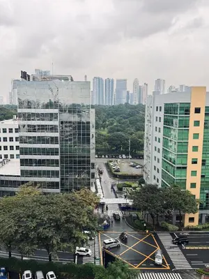 a city with tall buildings and a street with cars at Stamford Studio Condo in McKinley Hill, BGC Taguig in Manila