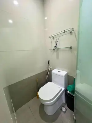 a bathroom with a white toilet in a room at City Comfort Studio at Sunshine 100 in Manila