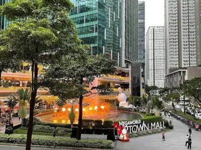 a large fountain in the middle of a city at La Rosa Home - Uptown BGC in Manila