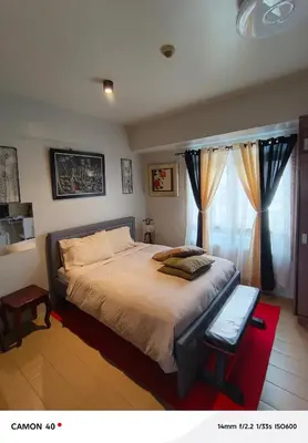a bedroom with a large bed and a window at 150 Newport Boulevard Condominium - North Wing in Manila