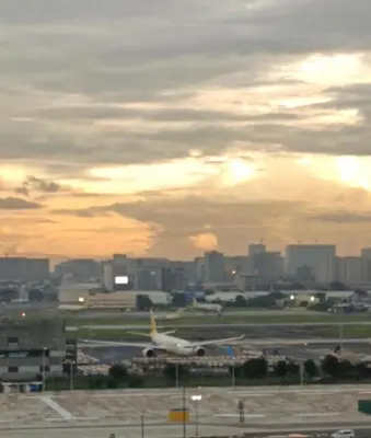 an airplane is on the runway at an airport at 150 Newport Boulevard Condominium - North Wing in Manila