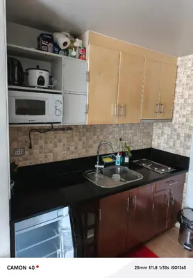 a kitchen with a sink and a microwave at 150 Newport Boulevard Condominium - North Wing in Manila
