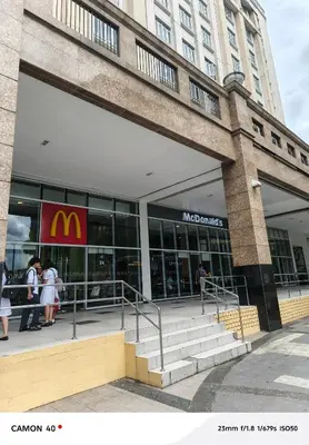 a mcdonalds building with people standing outside of it at 150 Newport Boulevard Condominium - North Wing in Manila