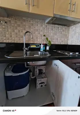 a kitchen counter with a sink and a trash can at 150 Newport Boulevard Condominium - North Wing in Manila