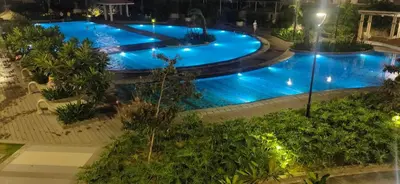 an overhead view of a pool at night at The Luxe at The Pent in Manila