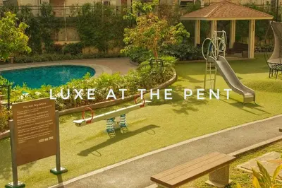 a park with a slide and a playground with the words love at at The Luxe at The Pent in Manila
