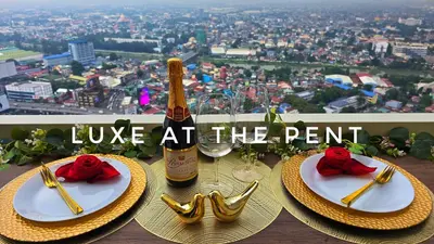 a table with two plates and two bottles of champagne at The Luxe at The Pent in Manila