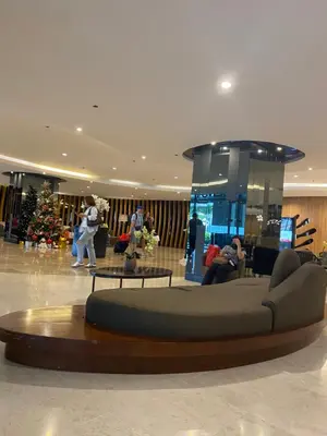 a lobby with a circular couch in the middle at Shore 2 residences tower 1 in Manila