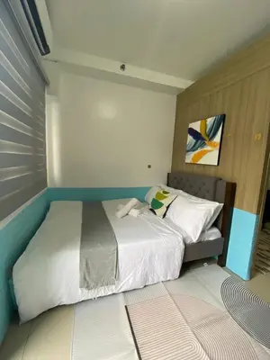 a small bedroom with a bed with white sheets at Shore 2 residences tower 1 in Manila