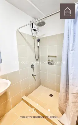 a shower in a bathroom with a glass door at The Cozy Home of Calleigh in Allegra in Manila