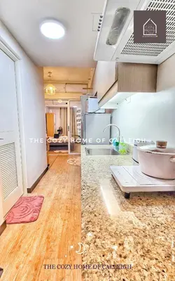 a kitchen with a counter top and a refrigerator at The Cozy Home of Calleigh in Allegra in Manila