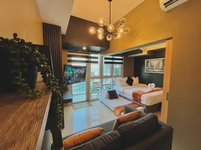 a large room with a bed and a couch at 1 Bedroom Luxe in BGC with Balcony & Free Parking in Manila