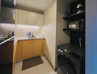 a small kitchen with a washing machine in it at 1 Bedroom Luxe in BGC with Balcony & Free Parking in Manila