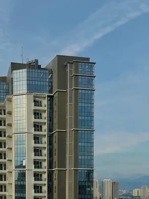 a tall building with glass windows on the side of it at 1 Bedroom Luxe in BGC with Balcony & Free Parking in Manila