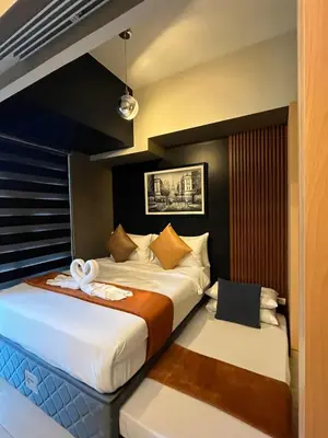 a hotel room with two beds in a room at 1 Bedroom Luxe in BGC with Balcony & Free Parking in Manila