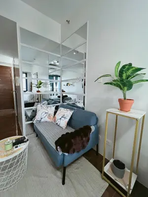 a dog laying on a couch in a living room at Pleasant Air Residences With Balcony and Fast Wi-Fi in Manila