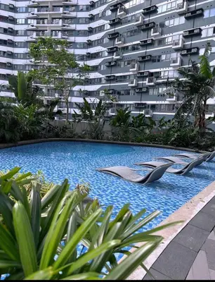 a swimming pool in front of a large apartment building at Pleasant Air Residences With Balcony and Fast Wi-Fi in Manila