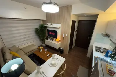 a living room with a couch and a tv at 2BR Air Residence, Makati City in Manila