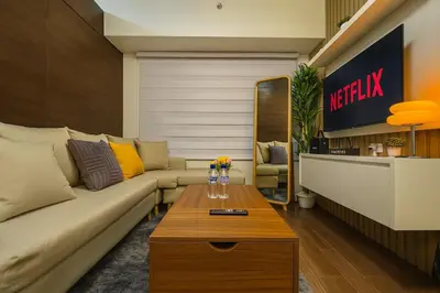 a living room with a couch and a table at 2BR Air Residence, Makati City in Manila