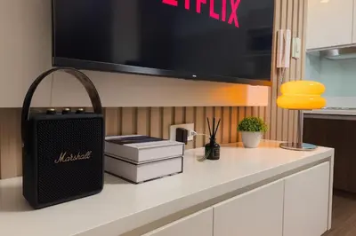 a counter with a television and books on it at 2BR Air Residence, Makati City in Manila