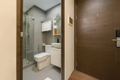 a bathroom with a toilet and a sink and a shower at 2BR Air Residence, Makati City in Manila