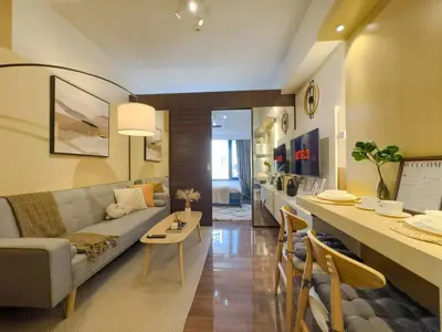 a living room with a couch and a bar in it at 1BR Makati, Air Residences M010 in Manila
