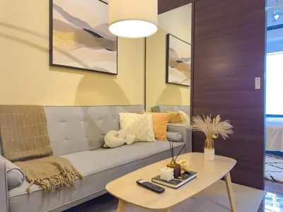 a living room with a couch and a table at 1BR Makati, Air Residences M010 in Manila
