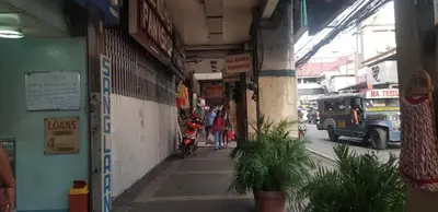 an alley with people walking down a street at Nemar Building GF room w AC in Manila