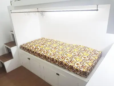a small bed in a room with a window at Nemar Building GF room w AC in Manila