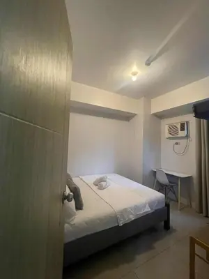 a small bedroom with a bed and a desk at 2 Bedroom Shore Residence Mall Of Asia Complex in Manila