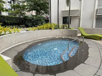 a small swimming pool in a building at Panoramic Views 2BR Family Stay in Mckinley BGC in Manila