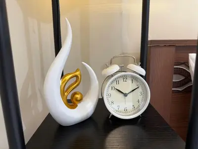 a alarm clock and a swan clock on a table at Panoramic Views 2BR Family Stay in Mckinley BGC in Manila