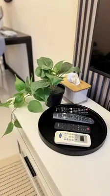 a remote control sitting on top of a table at Luxe and Modern 1BR Unit in BGC in Manila