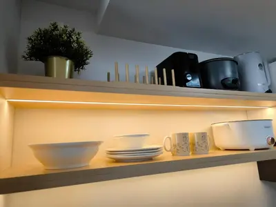 a shelf with bowls and plates and utensils on it at Prime Zen in Silang