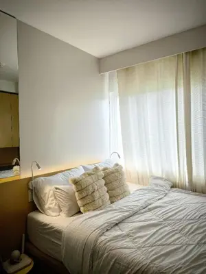 a bedroom with a bed with pillows and a window at Prime Zen in Silang