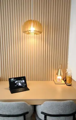 a laptop computer sitting on a desk with chairs at Prime Zen in Silang