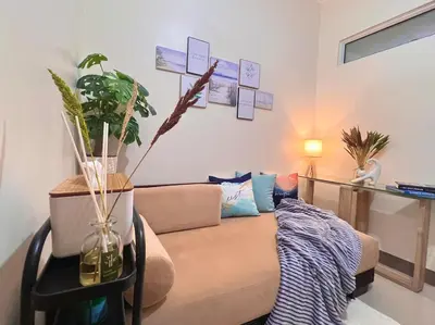 a living room with a couch and a table at 1 Bedroom Condo Unit Near SM City Sucat and NAIA Terminal in Manila
