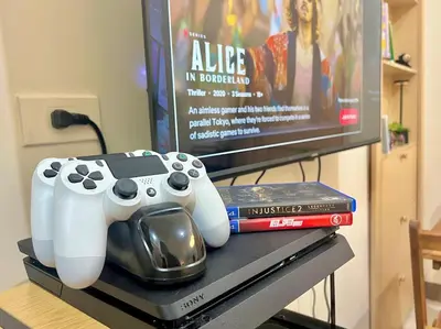 a video game controller sitting on a table next to a tv at 1 Bedroom Condo Unit Near SM City Sucat and NAIA Terminal in Manila