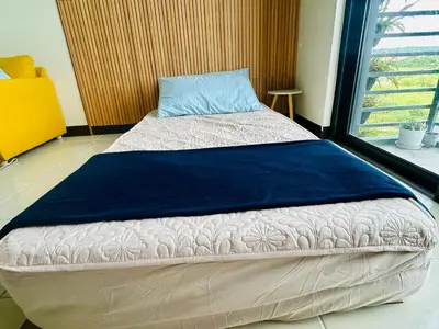 a large bed in a room with a window at Semi Furnished Condo at Sta Rosa Zadia Tower 2 in Sampong