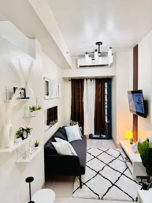 a living room with a couch and a tv at AR Pahinga Place - The Pause House in Manila
