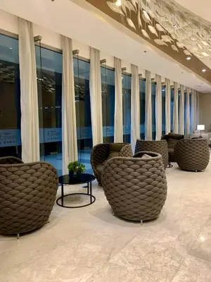 a lobby with couches and tables in a building at AR Pahinga Place - The Pause House in Manila