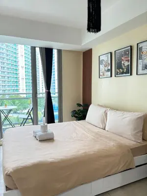 a bedroom with a large bed and a large window at Positano Tower Beach view with PS4 - Azure Parañaque Resort in Manila